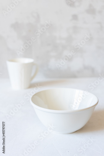 White dishes on a concrete background