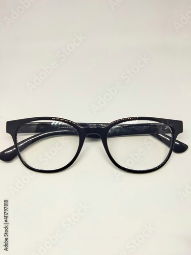 Anti-radiation glasses in black, placed on the table, anti-radiation glasses are used to block the rays from the light of smartphones or other technologies that damage eye vision.