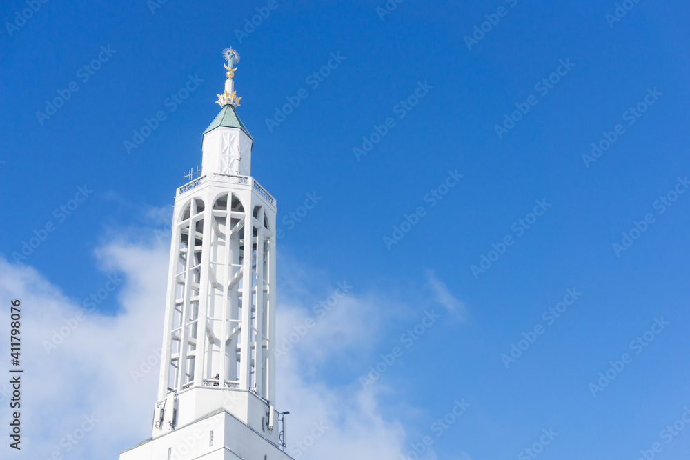 Saint Roch church in Bialystok city in Poland. White catherdal building. Empty copy space blue cloudy sky. Heaven background. Holy places in Europe. Architecture church tower.