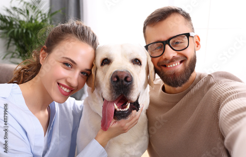 happy married couple  taking selfie with their favorite pet dog   at home