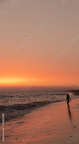 person walking on the beach at sunset © Antonio
