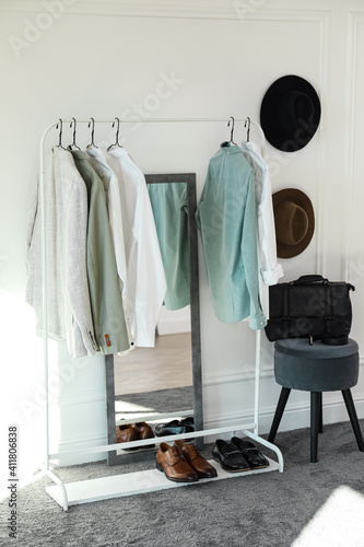 Rack with stylish clothes in modern dressing room © New Africa
