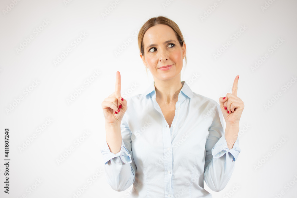 Portrait of young business woman pointing up over white background Portrait of young business woman pointing up over white background