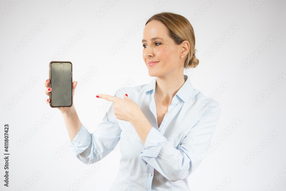 Young business woman showing smart phone over white background. Young business woman showing smart phone over white background.