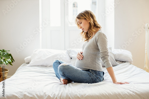 Portrait of young pregnant woman at home. © Anna