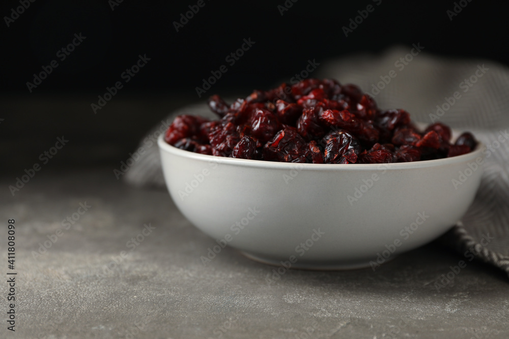 Bowl of dried cranberries on grey table, closeup Bowl of dried cranberries on grey table, closeup