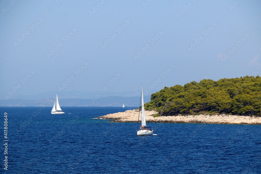 Sailing boat near island in Croatia. Beautiful Mediterranean landscape.