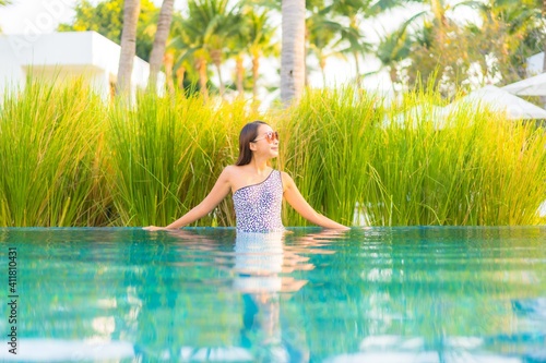 Portrait beautiful young asian woman relax smile enjoy leisure around swimming pool