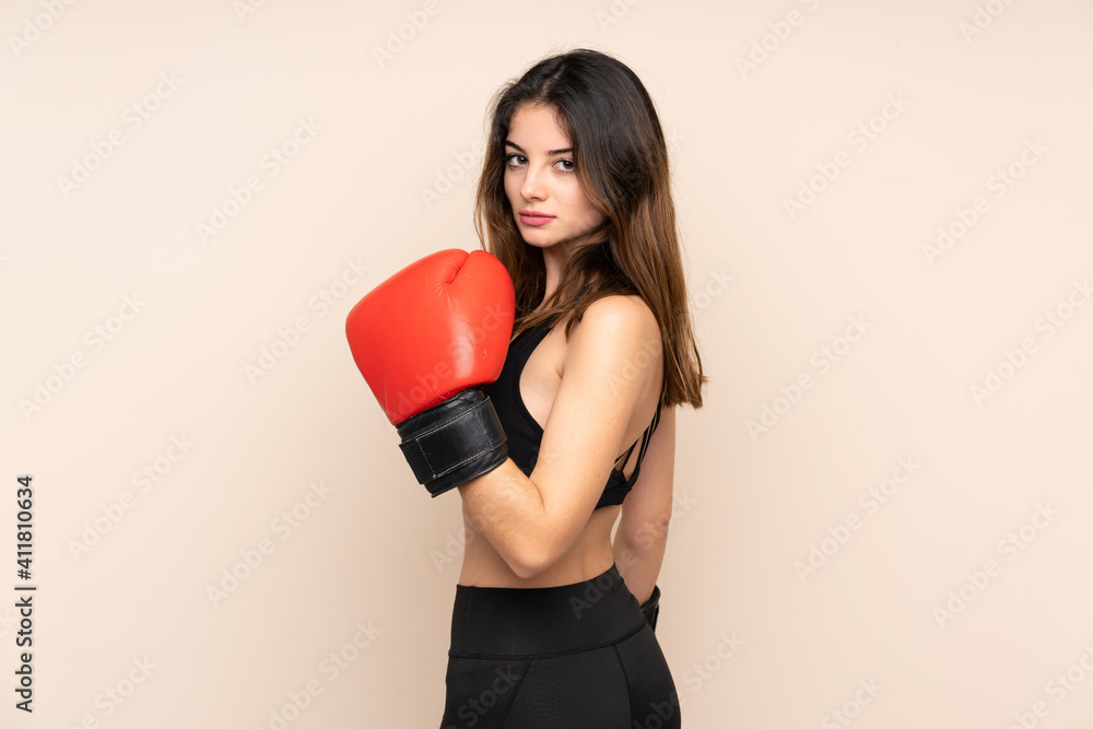 Young sport woman with boxing gloves over isolated background
