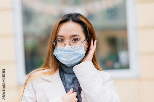 Asian woman with surgical mask, face protection in the city