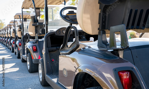 Background image of multiple golf carts parked in order.