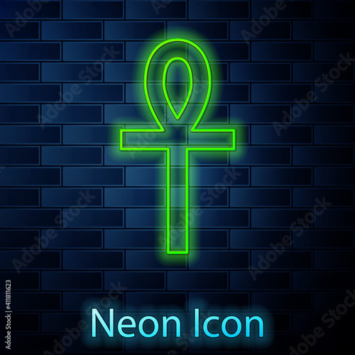 Glowing neon line Cross ankh icon isolated on brick wall background. Vector.