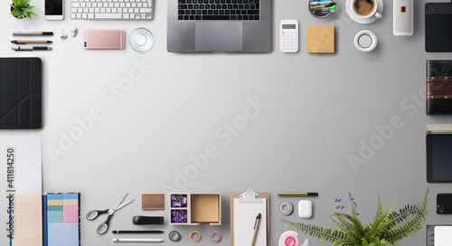 Flat lay top view office desk working space with laptop and supplies on gray background. Copy space. photo