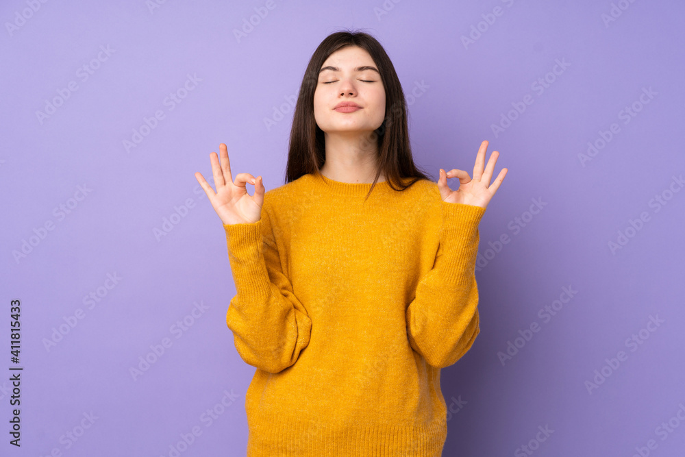 Young Ukrainian teenager girl over isolated purple background in zen pose Young Ukrainian teenager girl over isolated purple background in zen pose
