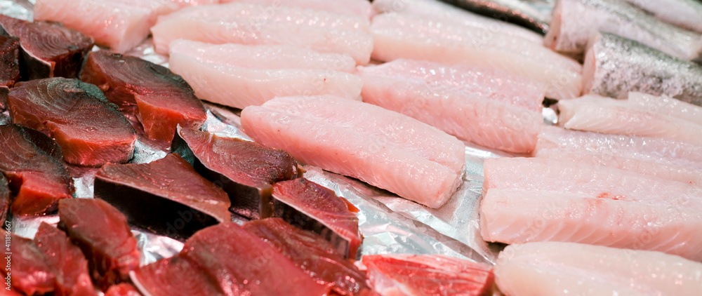 Fish market with fresh tuna steak and many other white fish meat. Fish market with fresh tuna steak and many other white fish meat.