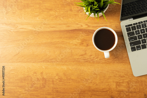 Workplace of office desk wooden table with laptop, and equipment other office supplies with copy space, flat lay