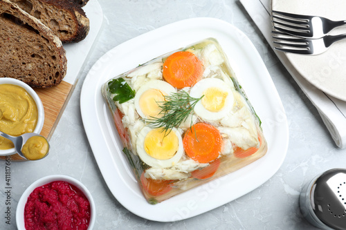 Delicious fish aspic served on grey marble table  flat lay