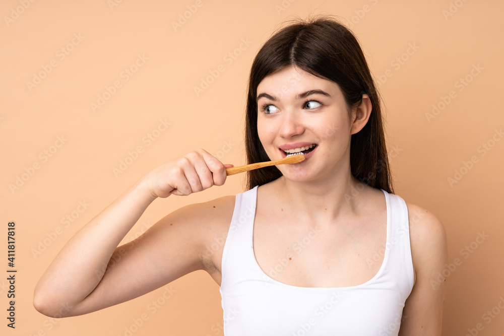 Young Ukrainian teenager girl over isolated background with a toothbrush Young Ukrainian teenager girl over isolated background with a toothbrush