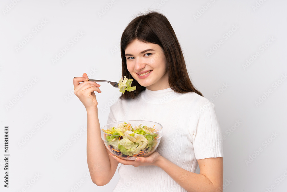Young Ukrainian teenager girl holding a salad over isolated white background Young Ukrainian teenager girl holding a salad over isolated white background