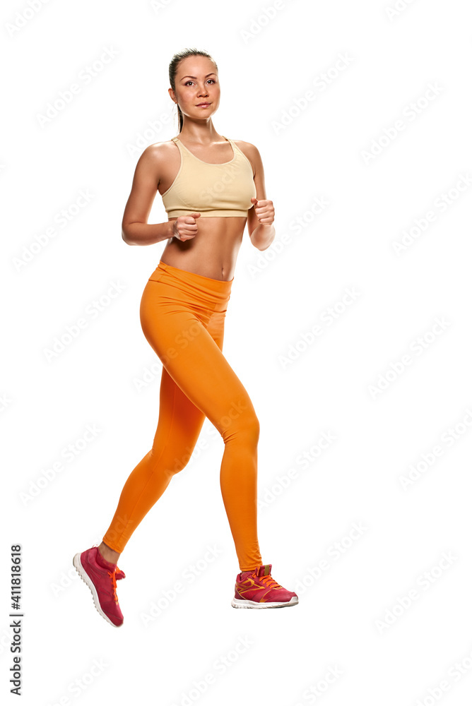 Beautiful young sporty woman running on white background Beautiful young sporty woman running on white background