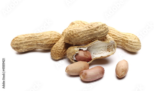 Shelled and unshelled peanuts pile isolated on white background