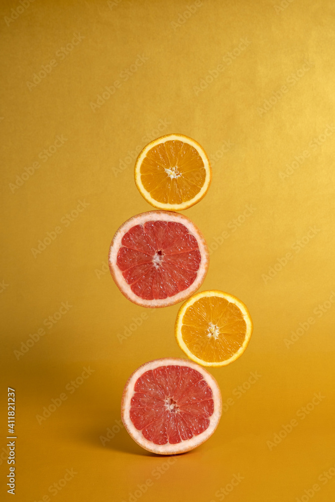 grapefruit and lemon stacked on top of each other levitate in space grapefruit and lemon stacked on top of each other levitate in space