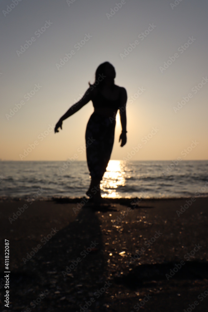 person on the beach at sunset