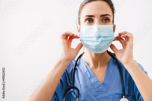 Beautiful young woman doctor in medical mask