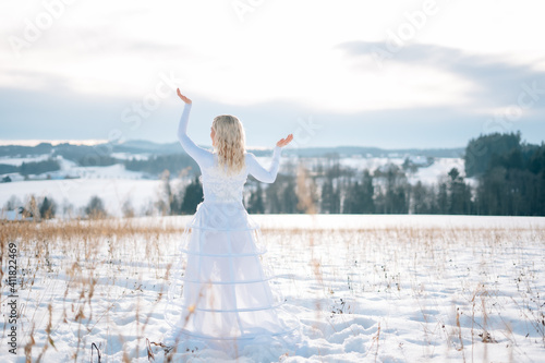 Frau in wei  em Schneekleid Haute Couture Hochzeitskleid Designerkleid wei   Winterlandschaft Schnee kalt Freude lacht