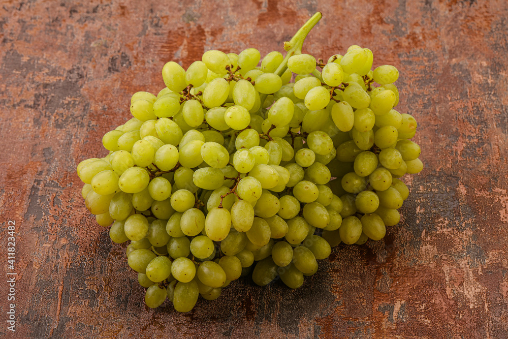 Green grape branch over background Green grape branch over background