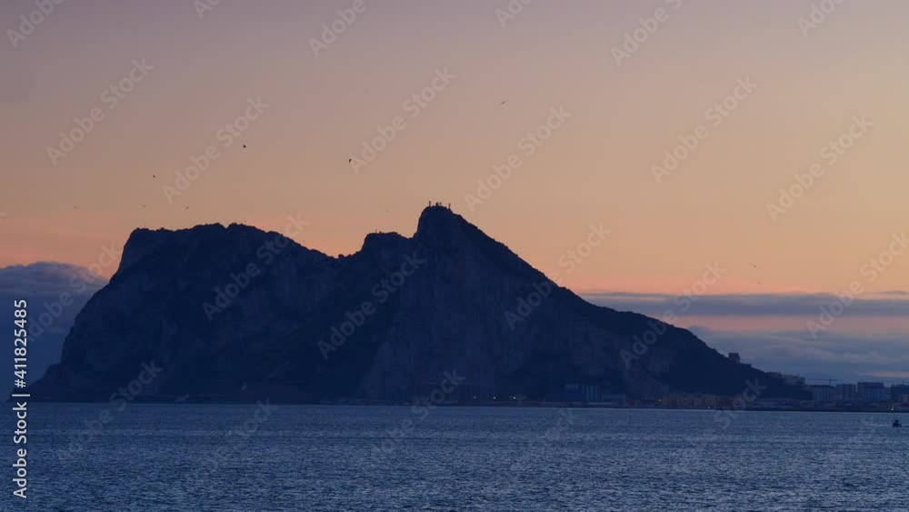 Gibraltar rock, british overseas territory on spanish coast. Evening time. View from Torrecarbonera beach, Punta Mala, Andalusia Spain. Tourist attraction. Gibraltar rock, british overseas territory on spanish coast. Evening time. View from Torrecarbonera beach, Punta Mala, Andalusia Spain. Tourist attraction.