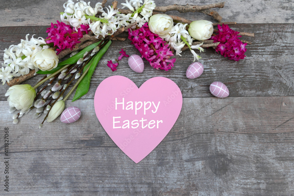 Easter card: Heart with the lettering Happy Easter and pink Easter eggs with white tulips Easter card: Heart with the lettering Happy Easter and pink Easter eggs with white tulips