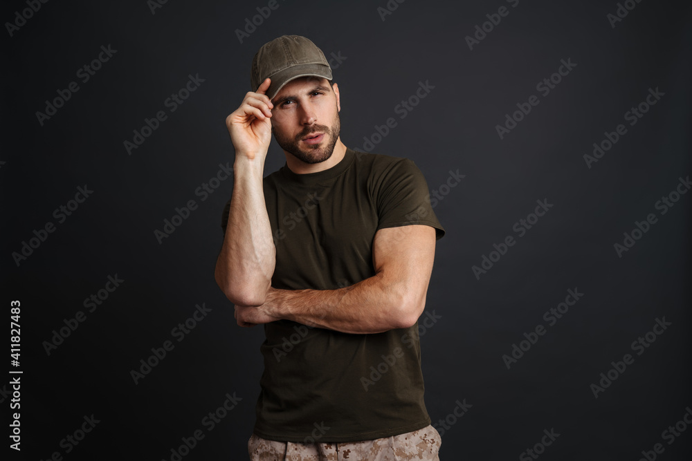 Focused masculine military man posing and looking at camera Focused masculine military man posing and looking at camera