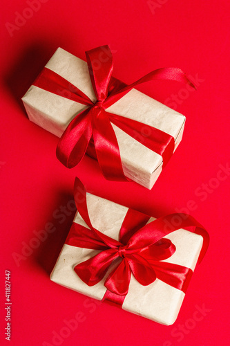 Zero waste gift boxes with festive ribbons on matte rad background