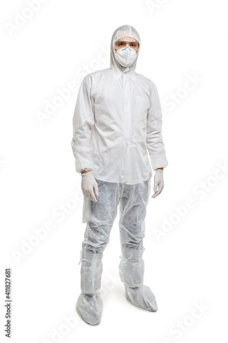 A male doctor in full-length chemical protection. He looks at the camera. White isolated background. © Evgenia