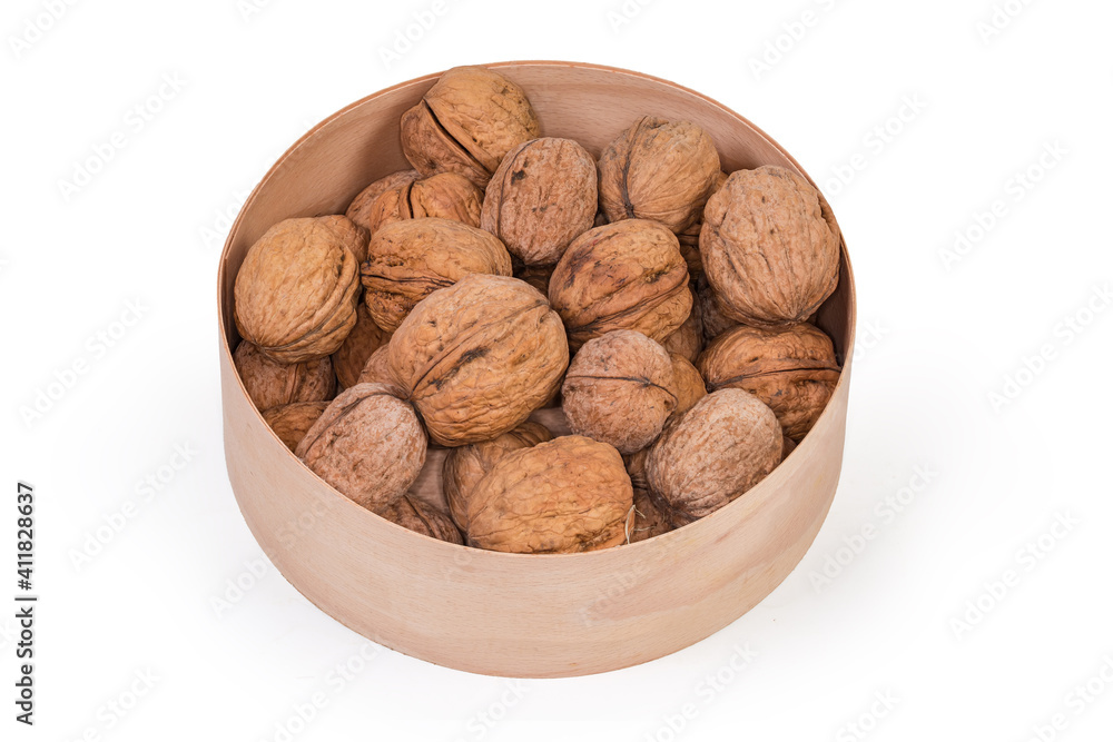 Dried walnuts in shells in a wooden round box Dried walnuts in shells in a wooden round box