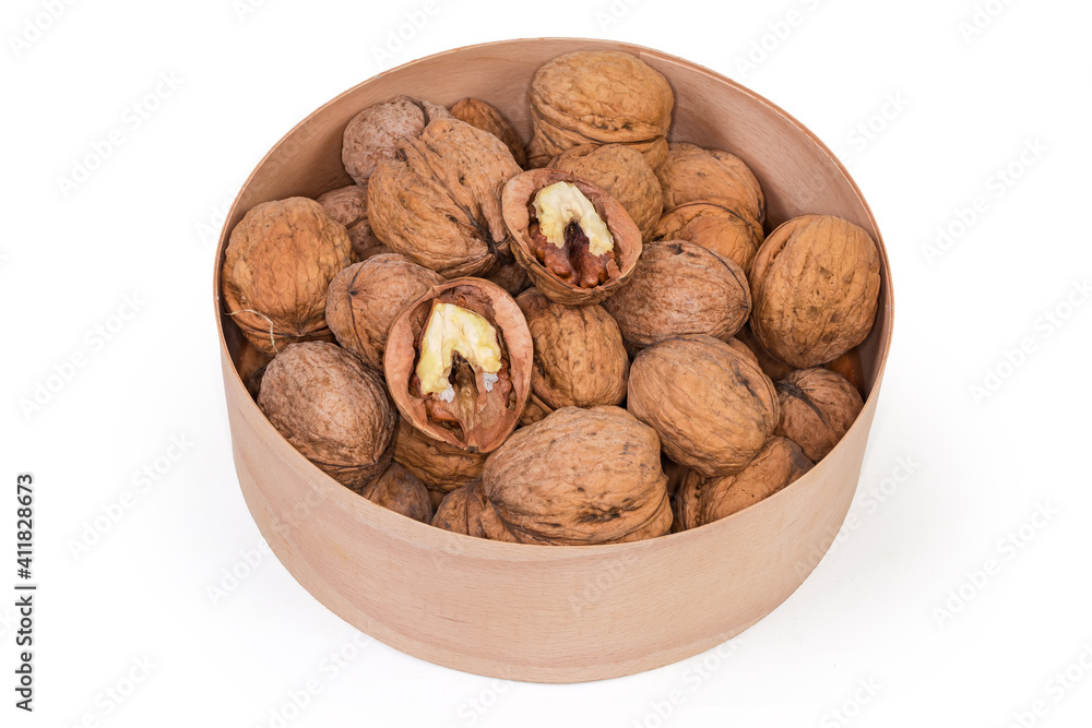 Dried walnuts in shells in a wooden round box Dried walnuts in shells in a wooden round box