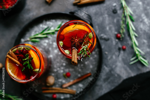 Hot mulled wine in a transparent glass on the table photo