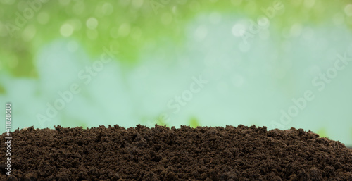 Brown soil surface with green background