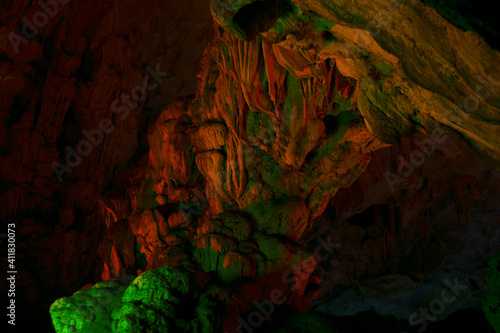 Stalactite and stalagmite formations in a limestone cave of Halong Bay,