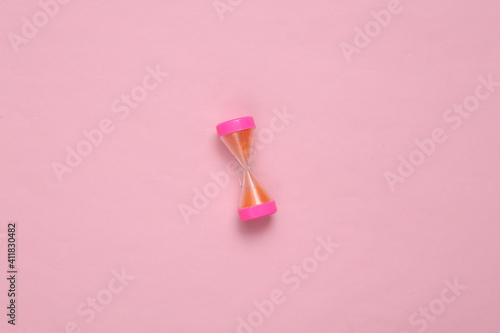 Hourglass on a pink pastel background. Top view. Minimalism © splitov27