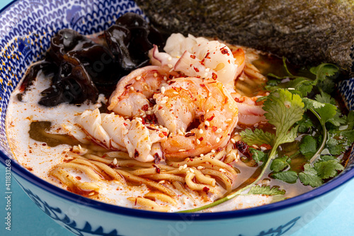 Closeup on asian ebi ramen noodle soup with mushrooms and shrimp photo