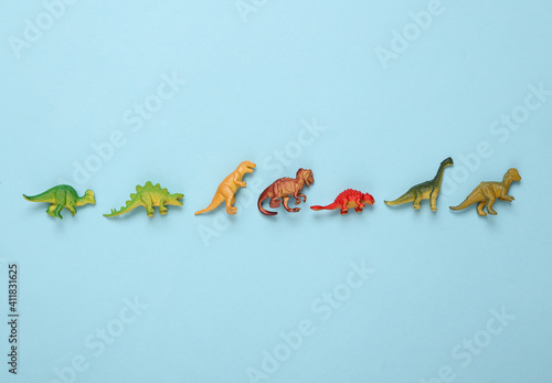 Toy dinosaurs on a blue background photo