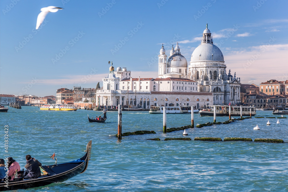 Grand Canal with gondola against Basilica Santa Maria della Salute in Venice, Italy
