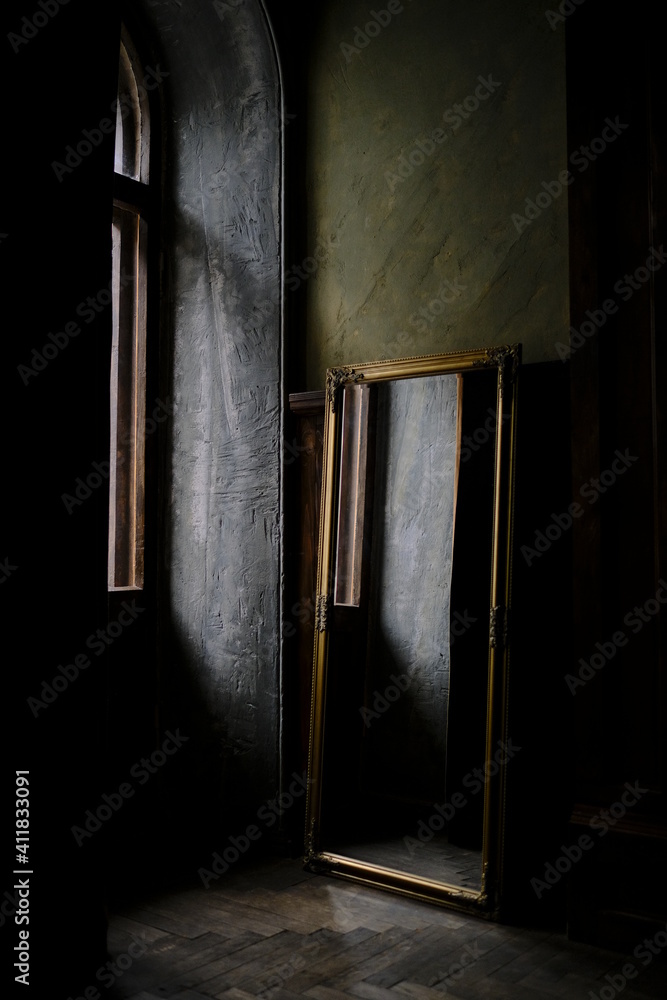 Antique mirror, stands by the window in a vintage room, beautiful apartment