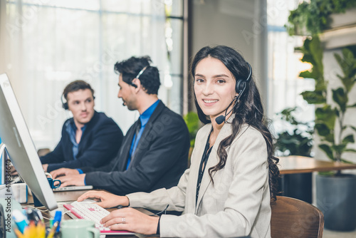 Vászonkép Beautiful Caucasion women on Tele Marketing representative or sales agents sitting at workplace wearing headset use computer, focus on call center
