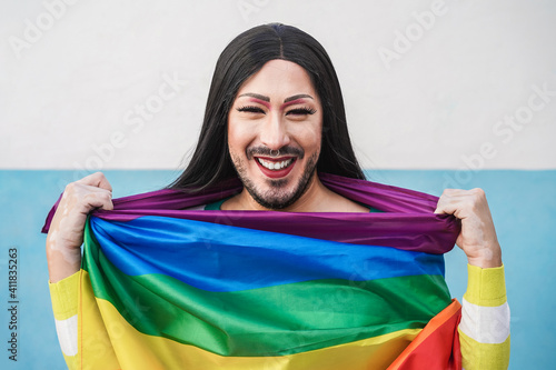 Happy drag queen wearing lgbt rainbow flag - Focus on face