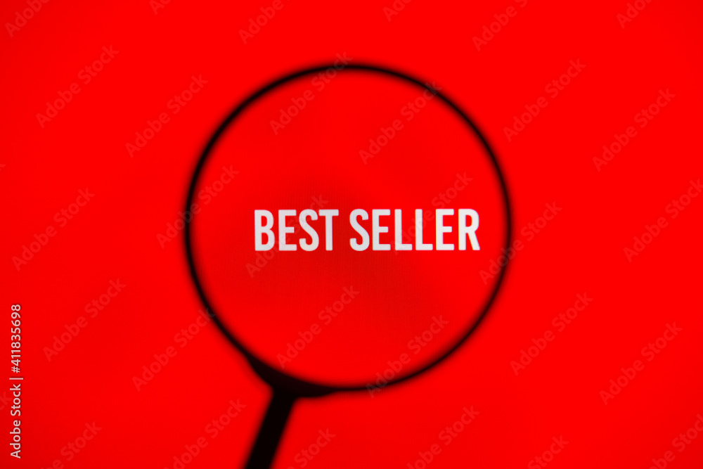 Text best seller on red screen through magnifying glass. Text best seller on red screen through magnifying glass.