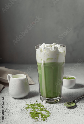 prepared matcha tea in a clear glass. a delicious drink made from Japanese green tea powder. vertical position