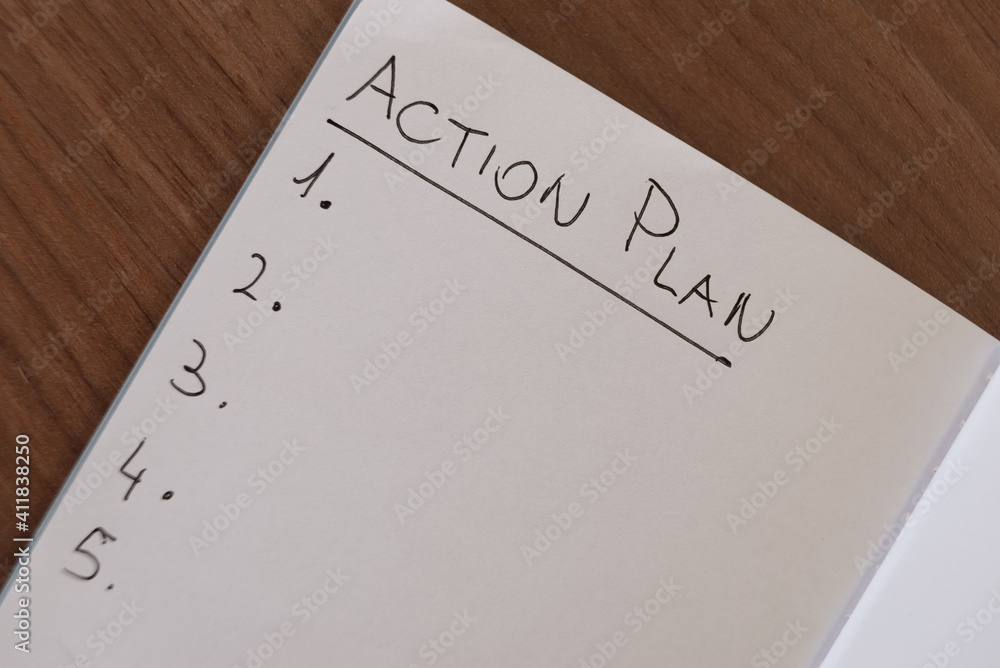 Notebook page marked 'Action plan' in black ink on white paper. Notebook page marked 'Action plan' in black ink on white paper.